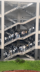 Students gather on exterior staircases of school building in Jiangjin