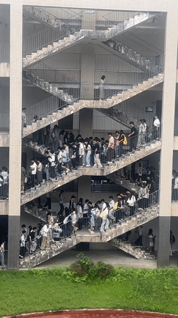 Students gather on exterior staircases of school building in Jiangjin