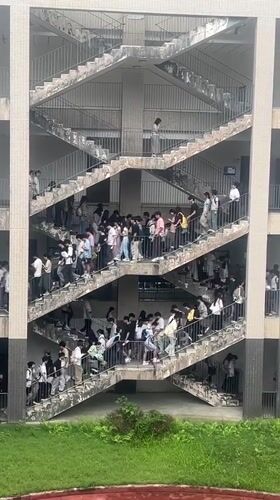 Students gather on exterior staircases of school building in Jiangjin