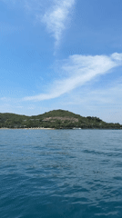 Island with beach facilities filmed from water near Nha Trang