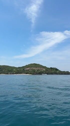 Island with beach facilities filmed from water near Nha Trang