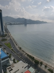 Aerial view captured of scenic coastal city with curved beach