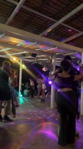 Nighttime dance party captured at thatched-roof bar in Thailand