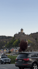 Tourist documents Reichsburg Cochem castle from Moselle River viewpoint