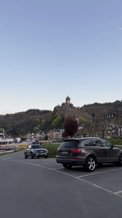 Tourist documents Reichsburg Cochem castle from Moselle River viewpoint