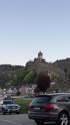 Tourist documents Reichsburg Cochem castle from Moselle River viewpoint