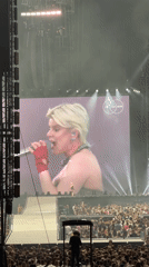 Blonde performer in black dress draws massive crowd Amsterdam concert