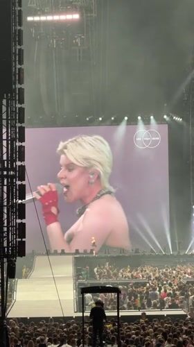 Blonde performer in black dress draws massive crowd Amsterdam concert