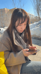 Woman enjoys sunny spring break on Kazan bench