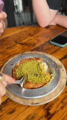 Diners photograph Middle Eastern dessert kunafeh in New York restaurant
