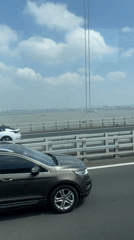 Vehicle crosses bridge in Yangzhong as SUV passes nearby