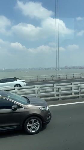 Vehicle crosses bridge in Yangzhong as SUV passes nearby