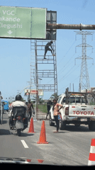 Worker maintains road sign in Igboefon, Nigeria