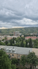 Overcast skies blanket Tbilisi's mixed architectural cityscape