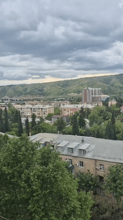 Overcast skies blanket Tbilisi's mixed architectural cityscape