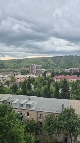 Overcast skies blanket Tbilisi's mixed architectural cityscape