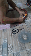 Fabric cutting and a standing fan in a Kendayakan workspace