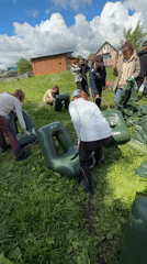 Group prepares inflatable rafts for water activity in Russia