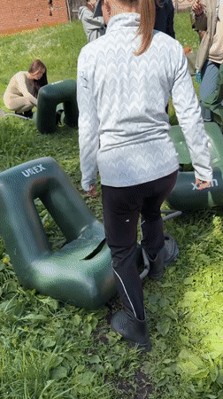 Group prepares inflatable rafts for water activity in Russia