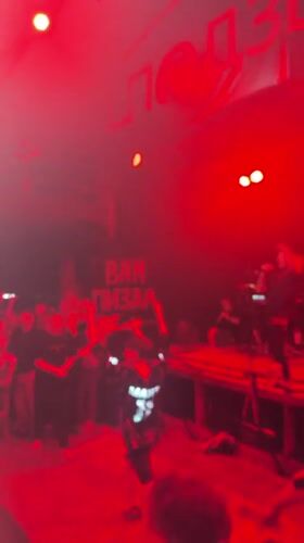 Five-piece band performs live concert in Novosibirsk under red lights