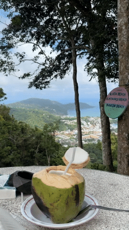 Coconut vendor serves drinks at Karon Thailand viewpoint