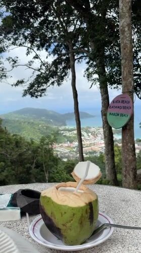 Coconut vendor serves drinks at Karon Thailand viewpoint