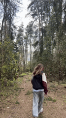 Woman enjoys forest outing with stroller near Раздолье, Russia