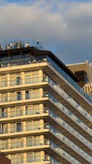Glass-railed balconies on a cloudy New York evening