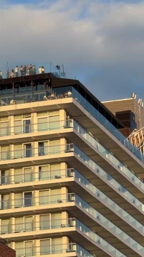 Glass-railed balconies on a cloudy New York evening