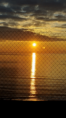 Sunrise captured through fence barriers in Varna, Bulgaria