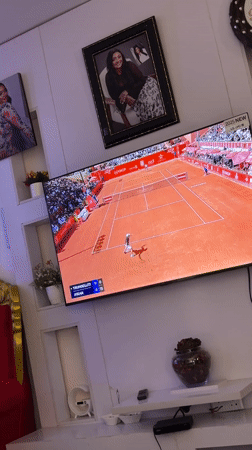 Jos resident watches varied TV programming in living room