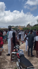 Crowd gathers outdoors in traditional attire, Jos, Nigeria