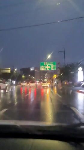 Rainy evening drive through Jeju City streets