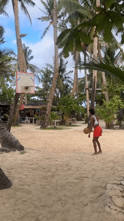 Beach basketball played on palm tree court in Philippines