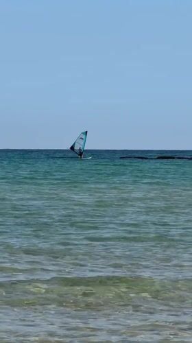 Serene morning captured at Bat Yam coast with windsurfing activity