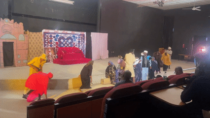 Live theater performance with traditional costumes on a decorated stage