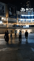 Women square dancing in Chongqing plaza interrupted by scooter