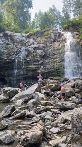 Hanging out at a rocky waterfall in Peshcherka, Russia