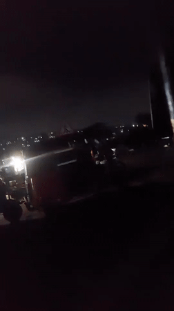 Three tuk-tuks parked on Dar es-Salaam street at night