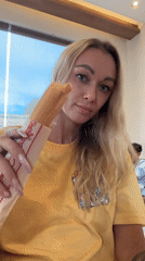 Woman enjoys banh mi at Highlands Coffee in Vietnam