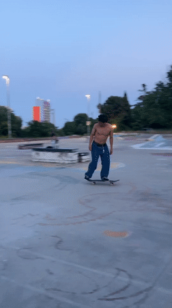 Skateboarder practices tricks at graffiti-covered Badalona skatepark
