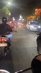 Street traffic and cat grooming captured in Denpasar