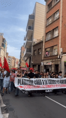 Anti-war protesters march through Barcelona streets carrying red flags