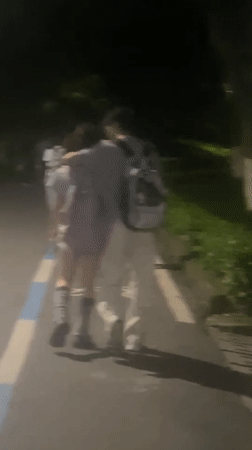 Nighttime pedestrians captured on Chongqing High-tech Zone pathway