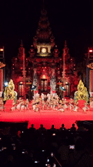 Traditional Balinese dance performance on ornate red stage in Denpasar