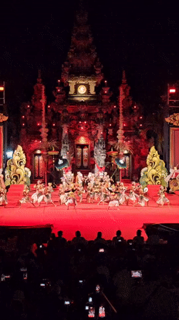 Traditional Balinese dance performance on ornate red stage in Denpasar