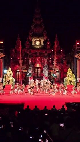 Traditional Balinese dance performance on ornate red stage in Denpasar