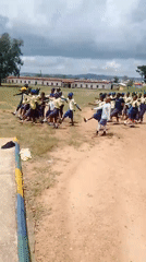 School students drill and march with flags in Jos, Nigeria