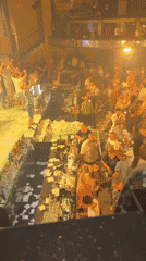 Crowded nightclub scene with scattered paper in Shumen