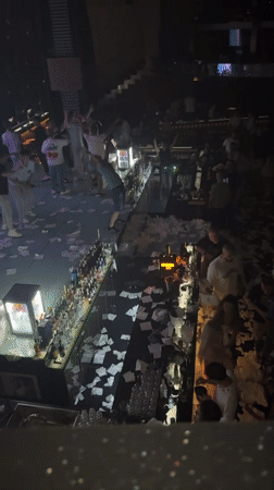 Crowded nightclub scene with scattered paper in Shumen